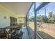 Screened porch with outdoor seating, overlooking the backyard at 8050 Memory Ln # 104, Rotonda West, FL 33947