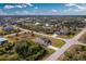 Aerial view of a single-Gathering home with a pool and a screened enclosure at 8104 Caroline Dr, Port Charlotte, FL 33981