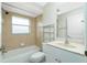 Bathroom with a bathtub, toilet, and vanity with a sink at 8104 Caroline Dr, Port Charlotte, FL 33981