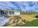 Back of house, showcasing the screened porch and large backyard at 9000 Falcon Ct, Venice, FL 34293