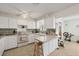 White kitchen with ample cabinetry and a breakfast bar at 9261 Saint Catherine Ave, Englewood, FL 34224