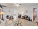 Open living room with comfy seating and views into kitchen area at 9261 Saint Catherine Ave, Englewood, FL 34224