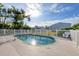 Relaxing kidney-shaped pool with a white fence at 9261 Saint Catherine Ave, Englewood, FL 34224