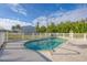 Refreshing kidney-shaped pool, surrounded by a white fence at 9261 Saint Catherine Ave, Englewood, FL 34224