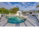 Inviting kidney-shaped pool with a white fence and patio at 9261 Saint Catherine Ave, Englewood, FL 34224