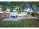 Inviting backyard patio with brick pavers, seating area, and a fire pit at 97 Lakeview Ln, Englewood, FL 34223