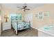 Bright bedroom with a metal bed frame and coastal decor at 97 Lakeview Ln, Englewood, FL 34223