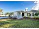 Front view of a renovated home with palm trees at 97 Lakeview Ln, Englewood, FL 34223