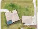 Aerial view of a home with pool and detached garage, surrounded by lush landscaping at 9822 Gulfstream Blvd, Englewood, FL 34224