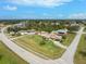 Aerial view of a single-Gathering home with a large yard and pool at 9822 Gulfstream Blvd, Englewood, FL 34224