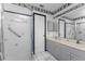 Bathroom with double vanity and a walk-in shower at 9822 Gulfstream Blvd, Englewood, FL 34224
