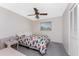 Bright bedroom with a queen-size bed and ceiling fan at 9822 Gulfstream Blvd, Englewood, FL 34224