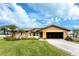 Beautiful single-story home with a two-car garage and lush landscaping at 9822 Gulfstream Blvd, Englewood, FL 34224