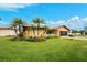 Attractive single-story home with palm trees and manicured lawn at 9822 Gulfstream Blvd, Englewood, FL 34224