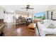 Living room with hardwood floors and kitchen view at 9822 Gulfstream Blvd, Englewood, FL 34224