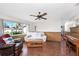Living room with hardwood floors and wood-paneled walls at 9822 Gulfstream Blvd, Englewood, FL 34224
