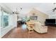 Open living area with hardwood floors, vaulted ceilings and a large window at 9822 Gulfstream Blvd, Englewood, FL 34224