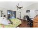 Main bedroom with pool view, large bed, and office area at 9822 Gulfstream Blvd, Englewood, FL 34224
