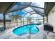 Relaxing kidney-shaped pool with covered lanai at 9822 Gulfstream Blvd, Englewood, FL 34224