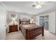 Bright bedroom with wooden frame bed and sliding glass door to patio at 1035 Oleander St, Englewood, FL 34223