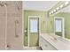 Bathroom with double vanity and access to bedroom at 11091 Corrigan Ave, Englewood, FL 34224
