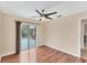 Bright bedroom with wood floors and sliding glass doors leading to the backyard at 11091 Corrigan Ave, Englewood, FL 34224