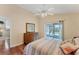 Bright bedroom with wood floors and sliding glass doors leading to backyard at 11091 Corrigan Ave, Englewood, FL 34224