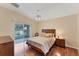 Main bedroom with hardwood floors and sliding door access to patio at 11091 Corrigan Ave, Englewood, FL 34224