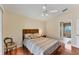 Charming bedroom with wood floors and access to bathroom at 11091 Corrigan Ave, Englewood, FL 34224