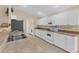 Well-equipped kitchen with white cabinets and ample counter space at 11091 Corrigan Ave, Englewood, FL 34224