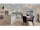 Bright kitchen with white cabinets, and adjoining dining area at 11091 Corrigan Ave, Englewood, FL 34224