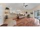 Open-concept living area with hardwood floors, and kitchen views at 11091 Corrigan Ave, Englewood, FL 34224