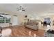 Open living area featuring hardwood floors and kitchen access at 11091 Corrigan Ave, Englewood, FL 34224