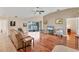 Spacious living room with hardwood floors, and access to a patio at 11091 Corrigan Ave, Englewood, FL 34224