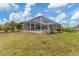 House exterior showcasing a large, screened pool area at 116 Hercules Dr, Rotonda West, FL 33947