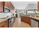 Kitchen boasts granite countertops and wood cabinets at 116 Hercules Dr, Rotonda West, FL 33947