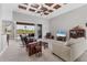 Spacious living room with hardwood floors, a coffered ceiling, and access to the pool area at 116 Hercules Dr, Rotonda West, FL 33947
