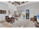 Living room with hardwood floors, coffered ceiling, and access to a lanai at 116 Hercules Dr, Rotonda West, FL 33947