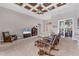 Living area with hardwood floors, coffered ceiling, and access to the lanai at 116 Hercules Dr, Rotonda West, FL 33947