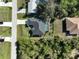 Aerial view of house, pool, and surrounding landscape at 12063 Claremont Dr, Port Charlotte, FL 33981