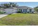 Newly built home with attached garage and well-manicured lawn at 12063 Claremont Dr, Port Charlotte, FL 33981