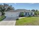 Newly built home with attached garage and well-manicured lawn at 12063 Claremont Dr, Port Charlotte, FL 33981