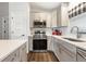 Modern kitchen with gray cabinets, stainless steel appliances, and quartz countertops at 12063 Claremont Dr, Port Charlotte, FL 33981