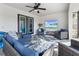 Relaxing covered patio with seating and large TV at 12063 Claremont Dr, Port Charlotte, FL 33981