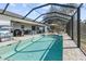 Large screened pool with surrounding patio furniture at 12063 Claremont Dr, Port Charlotte, FL 33981