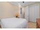 Bedroom with white bedding and double doors to closet at 13048 Creekside Ln, Port Charlotte, FL 33953