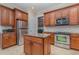 Island kitchen with granite countertop, stainless steel appliances, and wooden cabinets at 13048 Creekside Ln, Port Charlotte, FL 33953