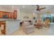 Open concept kitchen and living area with a breakfast bar and wooden cabinets at 13048 Creekside Ln, Port Charlotte, FL 33953