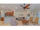 Living room with wooden chairs, a coffee table, and a view of the kitchen at 13048 Creekside Ln, Port Charlotte, FL 33953