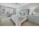 Spacious bedroom with a light blue headboard and plenty of natural light at 13213 Gasparilla Rd # B601, Placida, FL 33946